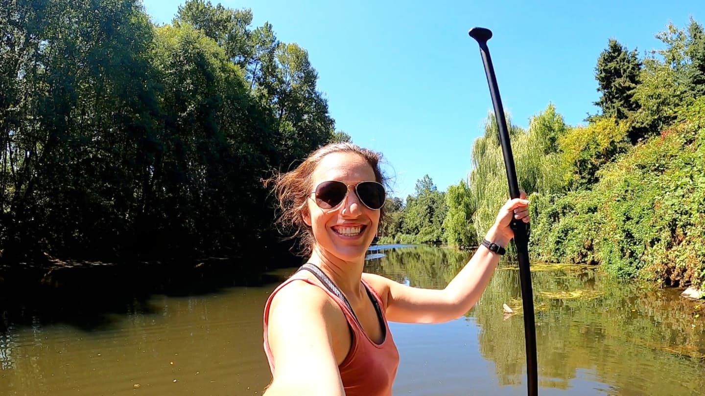 Person taking a selfie while paddleboarding on the Sammamish River in Bothell, WA