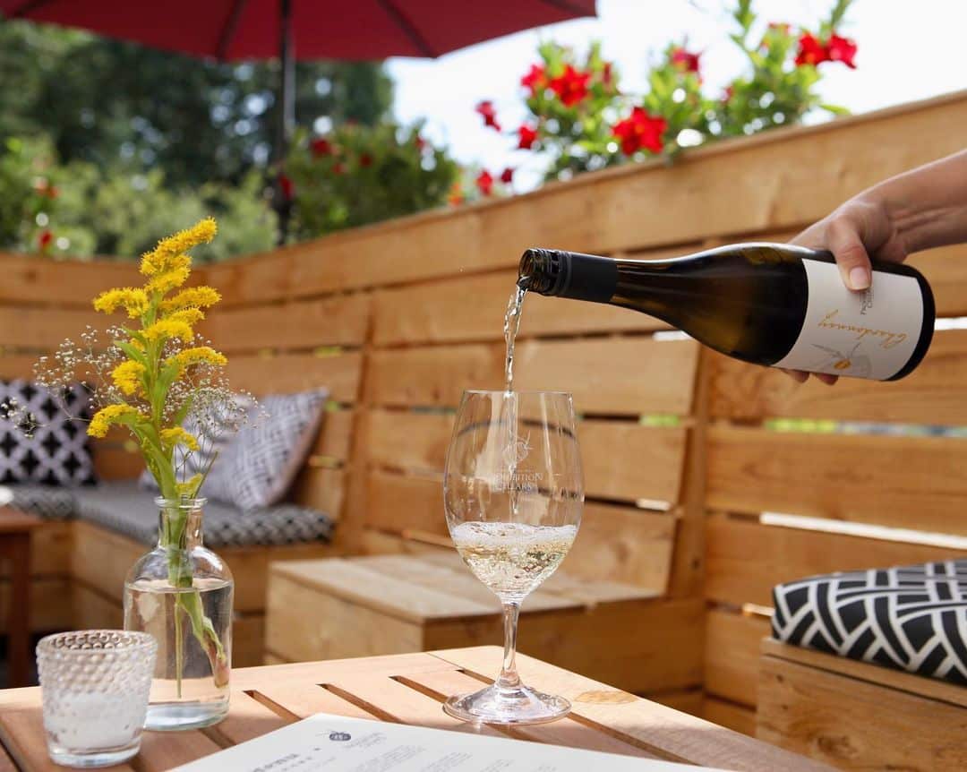 Wine pouring into a wine glass on outdoor patio