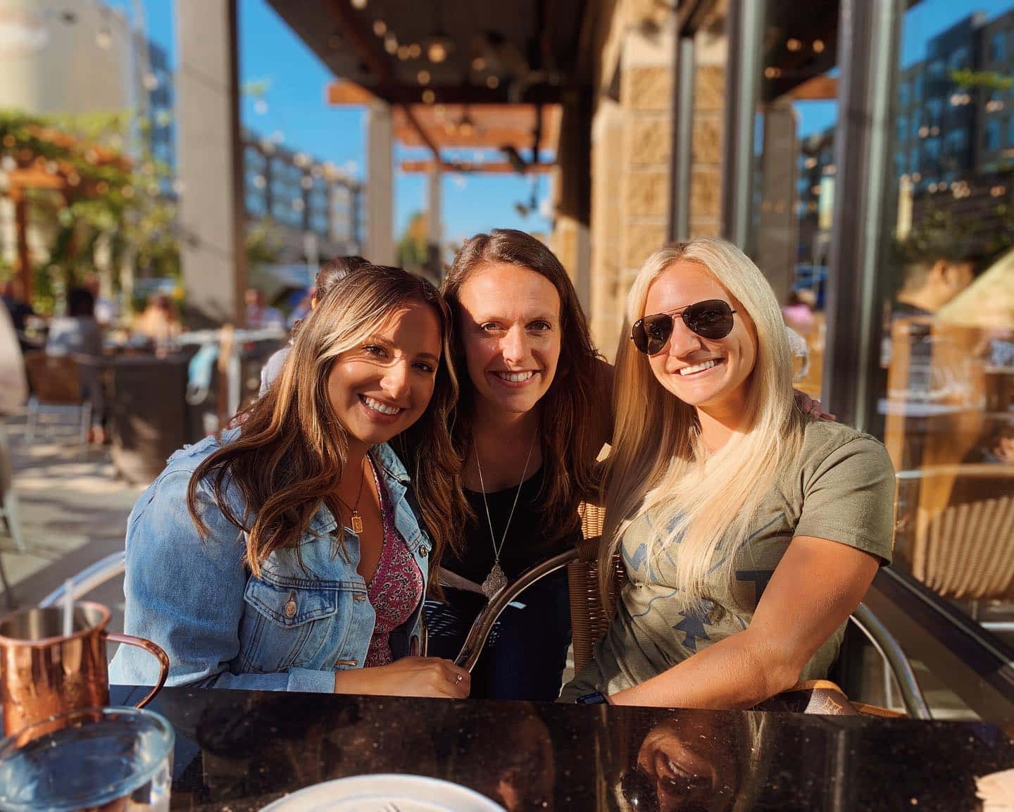 Three people smiling together.