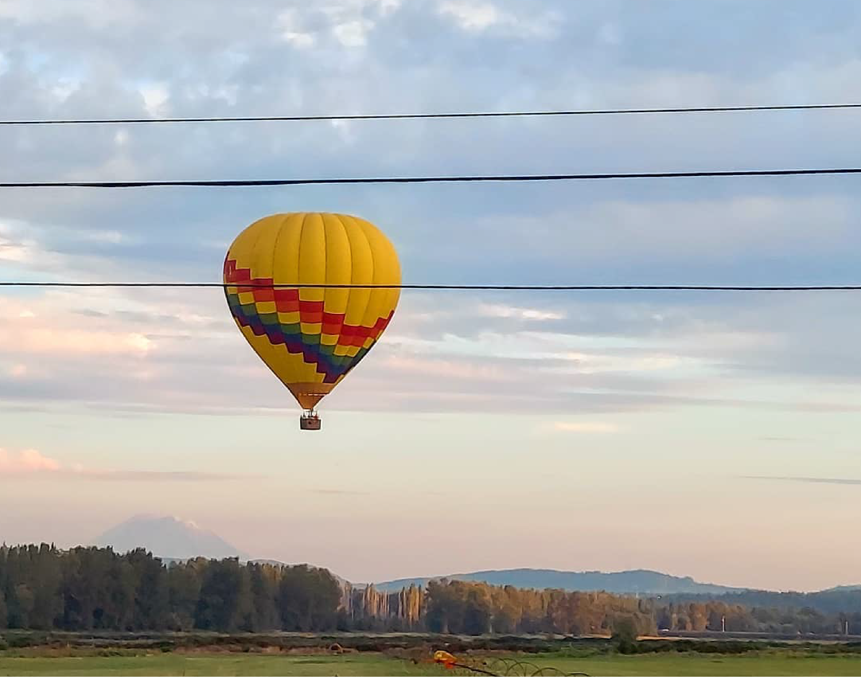 Hot air balloon over sunset.