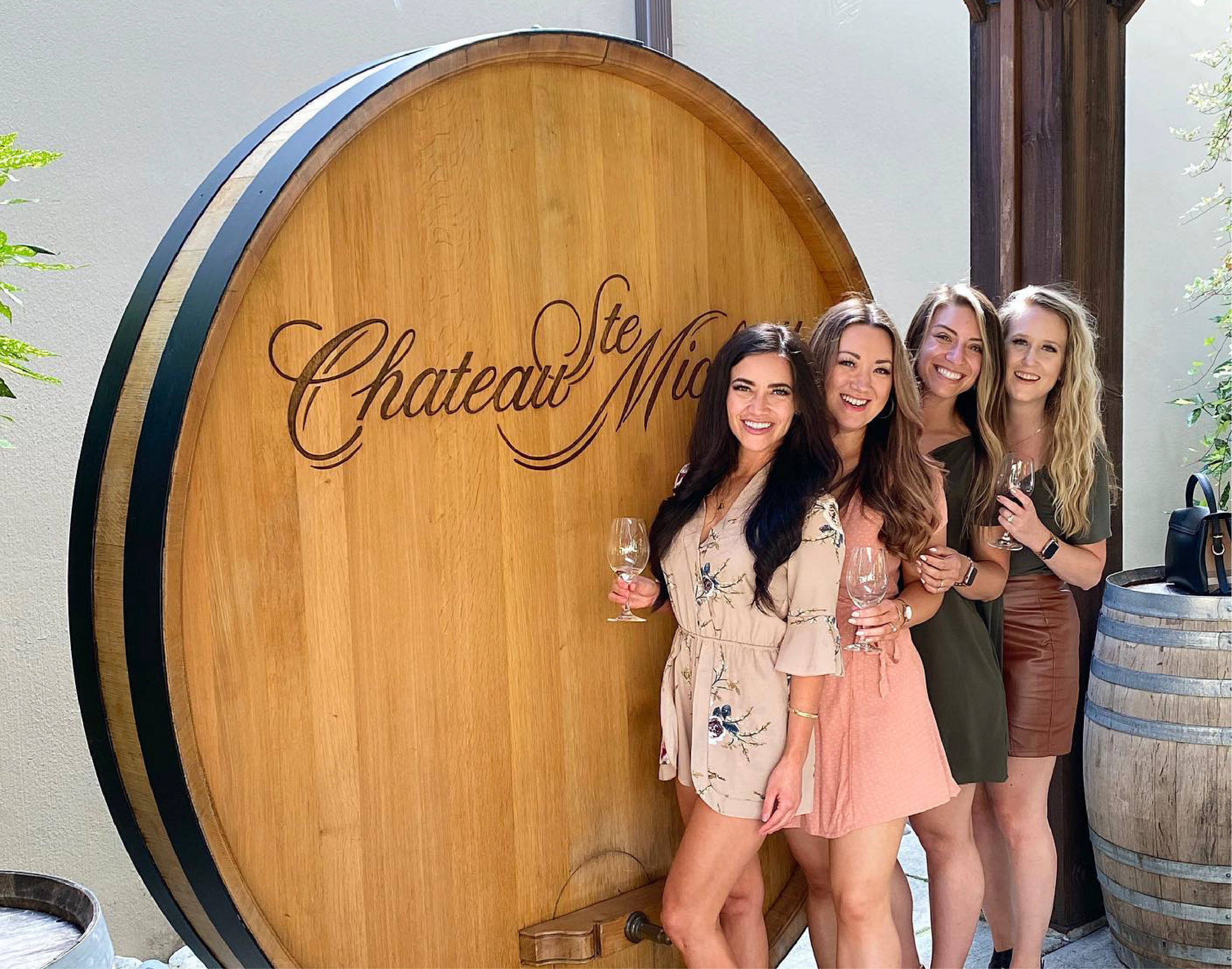 Four people posing at a winery.